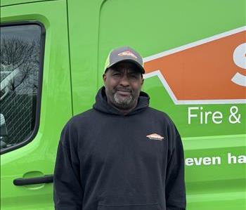 SERVPRO employee in front of green truck