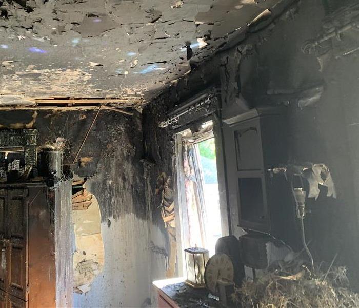 A dining room ceiling of a home damaged by an electrical fire