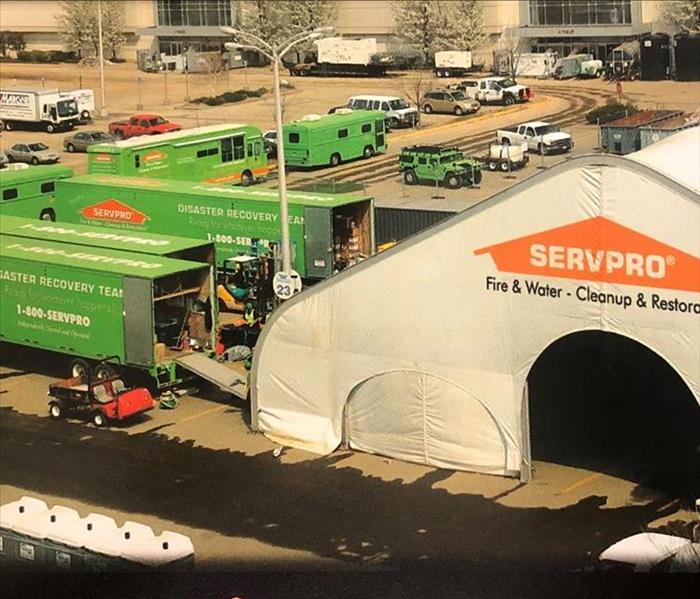 Retail stores in a parking lot with SERVPRO vehicles